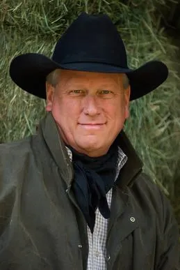 A man in a cowboy hat and jacket.